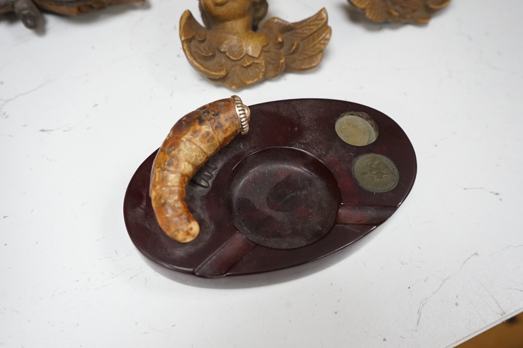 A Chinese carved wood box, two pairs of mounted deer horns, two carved wood cherub heads, an ashtray and an olivewood box, large box 29.5cm x 15cm high. (7)